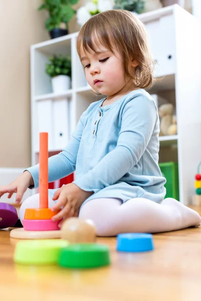 Toddler girl playing with toys — Stock Photo, Image
