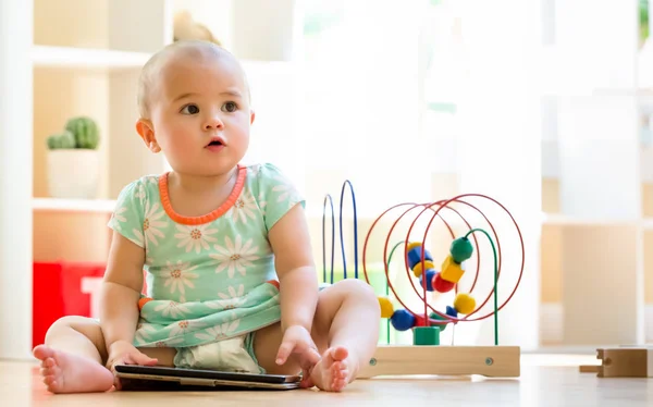 Toddler girl watching a tablet computer — Stock Photo, Image