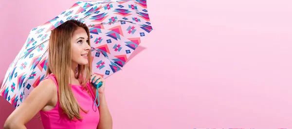 Happy young woman holding an umbrella — Stock Photo, Image
