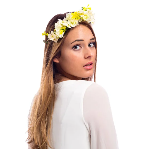 Mooie vrouw met een bloem slinger en een witte jurk — Stockfoto