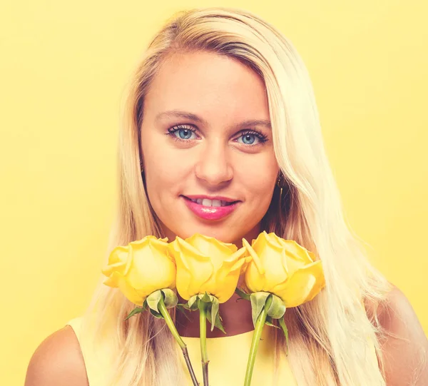 Young woman with flowers — Stock Photo, Image