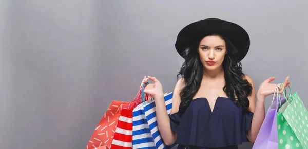 Happy young woman holding shopping bags — Stock Photo, Image