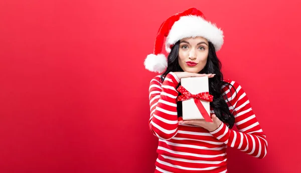 Young woman holding a Christmas gift — Stock Photo, Image