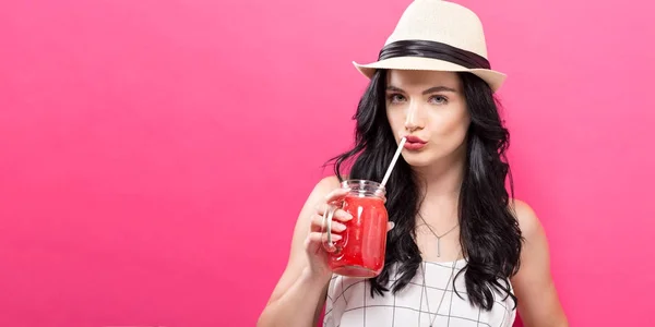 Happy young woman drinking smoothie — Stock Photo, Image