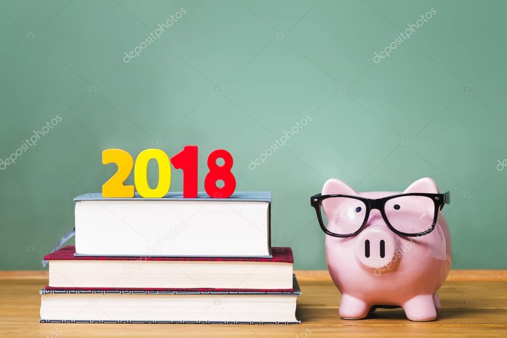 Class of 2018 theme with textbooks and piggy bank