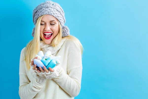 Happy young woman holding heart cushions — Stock Photo, Image