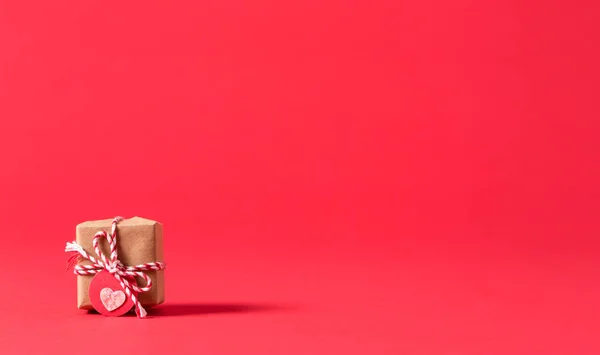 Коробка подарков на красном фоне — стоковое фото