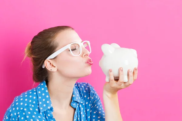 Young woman with a piggy bank — Stock Photo, Image