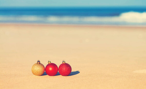 Christmas ornaments on a tropical beach