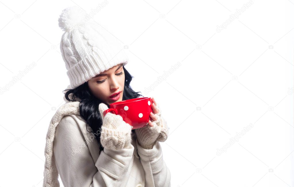 Woman in winter clothes drinking coffee