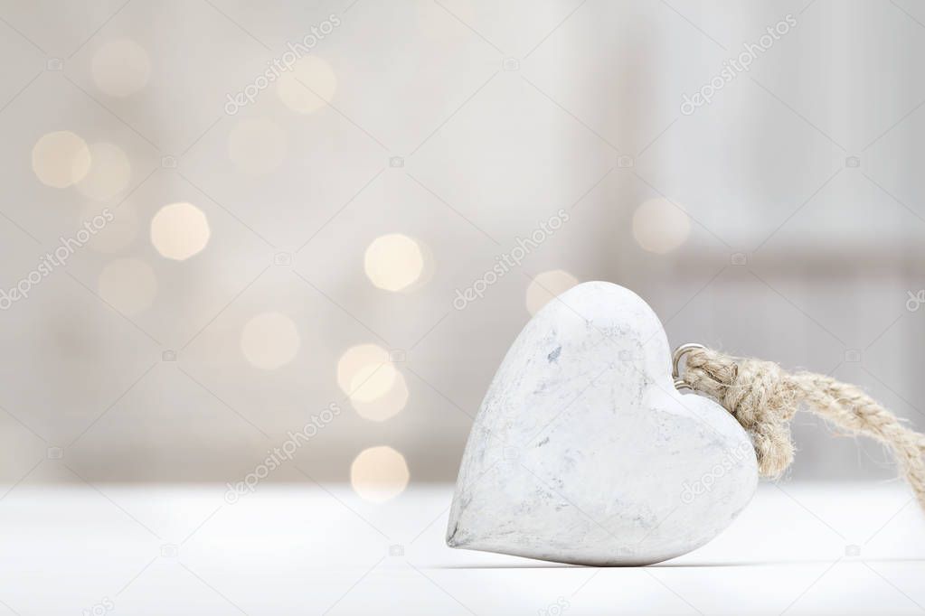 Wooden heart on abstract light background