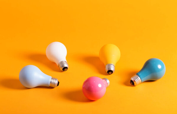 Colored light bulbs on a yellow background