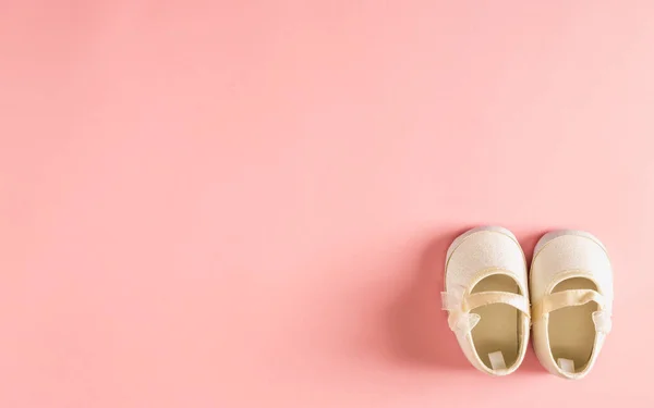 Zapatos de bebé sobre un fondo rosa —  Fotos de Stock