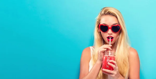 Gelukkig jonge vrouw drinken smoothie — Stockfoto