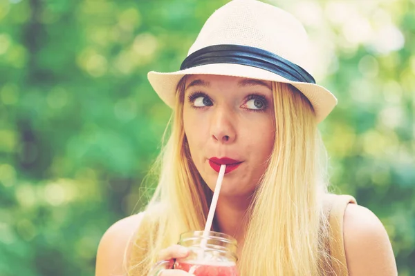 Jovem mulher bebendo um smoothie fora — Fotografia de Stock