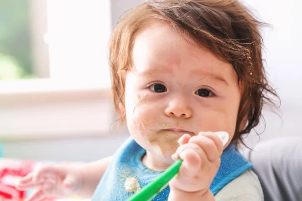 Happy little baby boy eating food — Stock Photo, Image