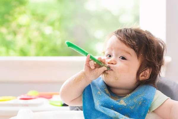 Happy little baby boy eating food — Stock Photo, Image