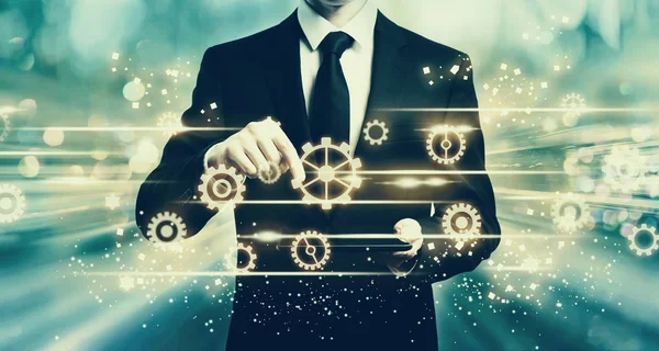 Gears with man holding a tablet — Stock Photo, Image