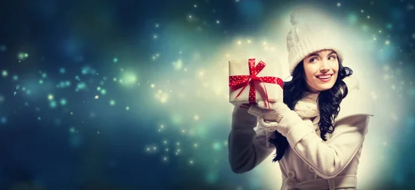 Young woman holding a Christmas gift Stock Photo