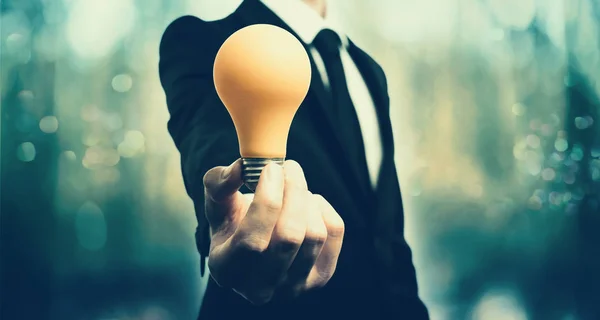 Businessman showing a lightbulb, inspiration concept — Stock Photo, Image