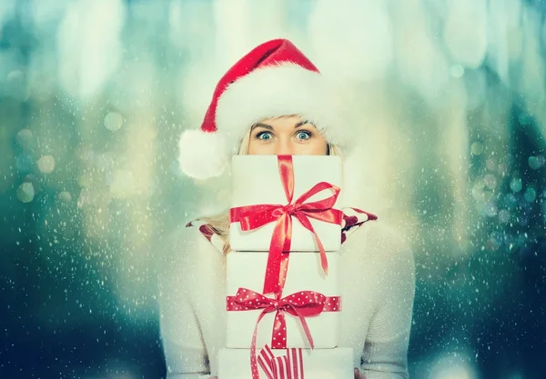 Happy young woman holding present boxes — Stock Photo, Image