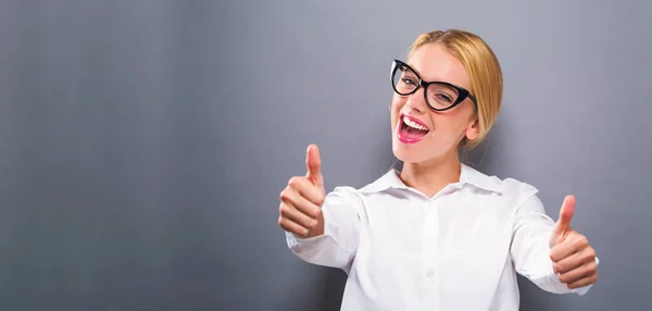 Happy young woman giving thumbs — Stock Photo, Image