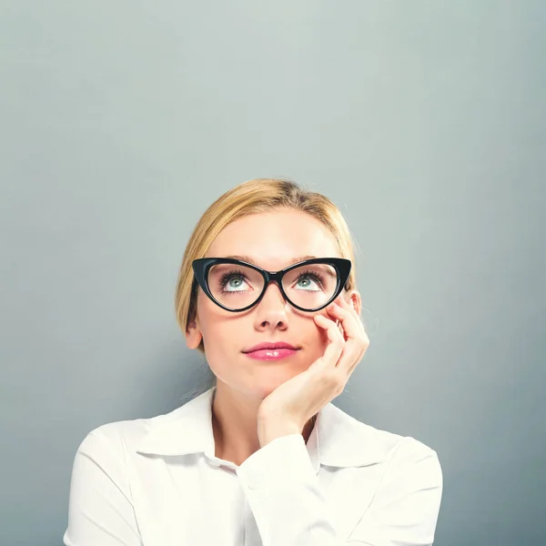 Young businesswoman in a thoughtful pose — Stock Photo, Image