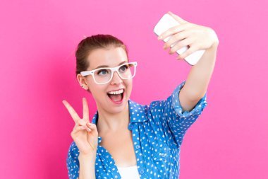 Genç bir kadın selfie çekiyor.