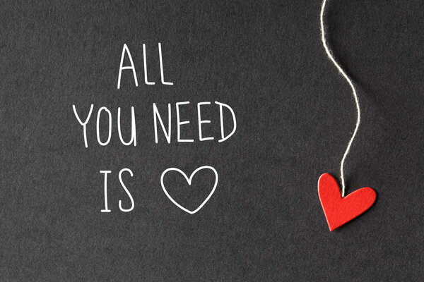 All You Need Is Love message with paper hearts