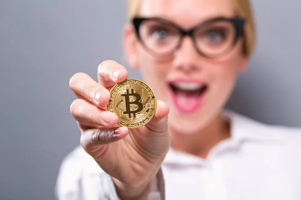 Kobieta trzyma fizyczne bitcoin — Zdjęcie stockowe