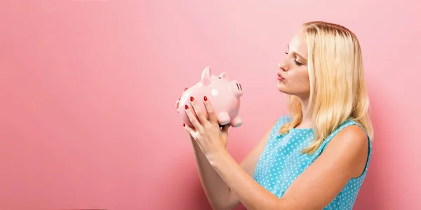 Young woman with a piggy bank — Stock Photo, Image