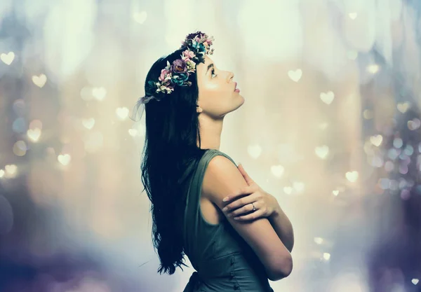 Beautiful young woman with a garland — Stock Photo, Image