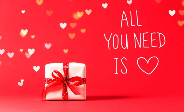 All You Need Is Love message with present box with heart lights — Stock Photo, Image