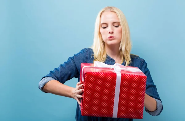 Joyeux jeune femme tenant une boîte cadeau — Photo