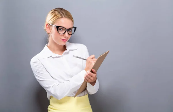 Office woman with a clipboard Royalty Free Stock Photos