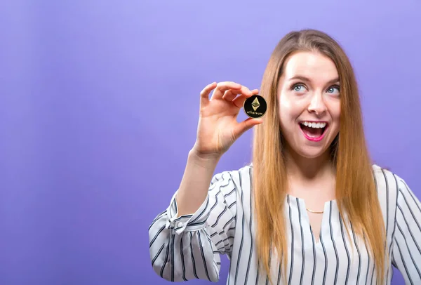 Woman holding a physical ethereum coin — Stock Photo, Image