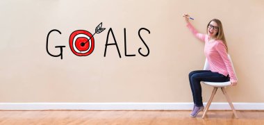 Bir kalem tutan genç kadın ile gol