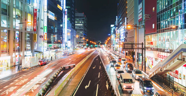 Traffic and people moving through Osaka, Japan at night