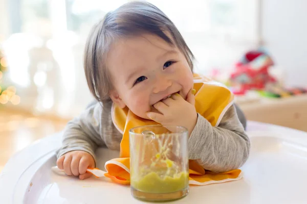 Happy little baby boy eating food — Stock Photo, Image
