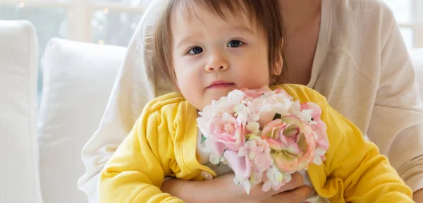 Bambino ragazzo con sua madre che tiene i fiori — Foto Stock