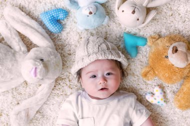 Onun doldurulmuş hayvanlar üzerinde bir halı ile erkek bebek