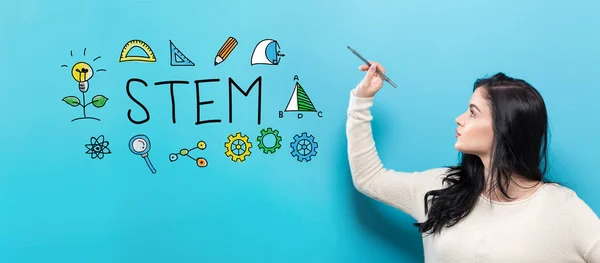STEM with young woman holding a pen — Stock Photo, Image