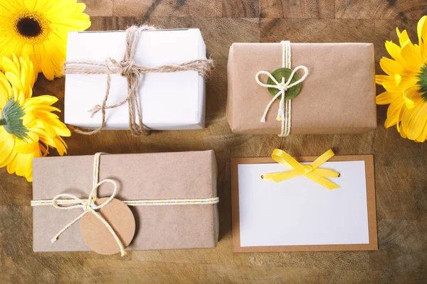 Little gift boxes with with yellow flowers — Stock Photo, Image