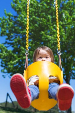 Salıncakta sallanan yürümeye başlayan çocuk