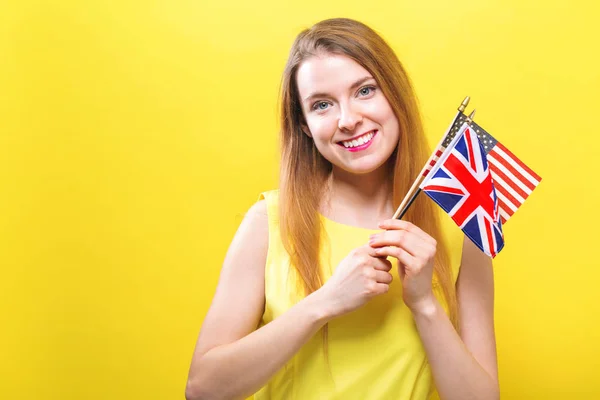 Jonge vrouw met vlaggen van Engels-sprekende landen — Stockfoto