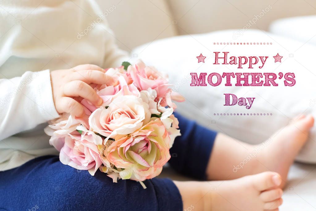 Mothers Day message with toddler boy with flowers 