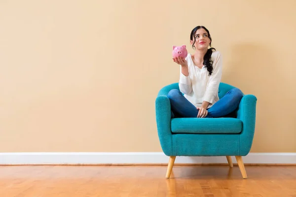 Young woman with a piggy bank — Stock Photo, Image