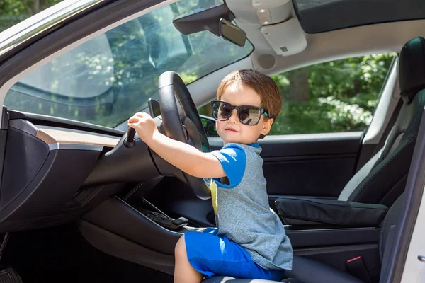 Niño jugando en un coche — Foto de Stock