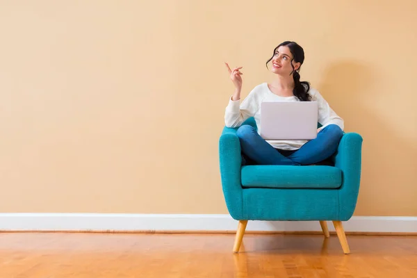 Giovane donna con un computer portatile che punta qualcosa — Foto Stock