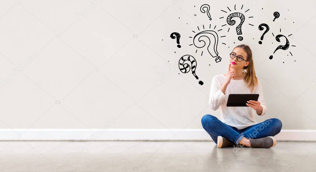Question marks with woman using a tablet